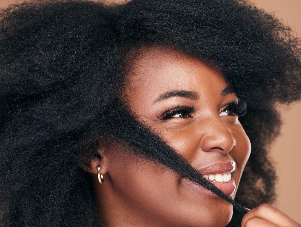 Beauty, hair and happy with a model black woman in studio on a brown background for natural cosmeti